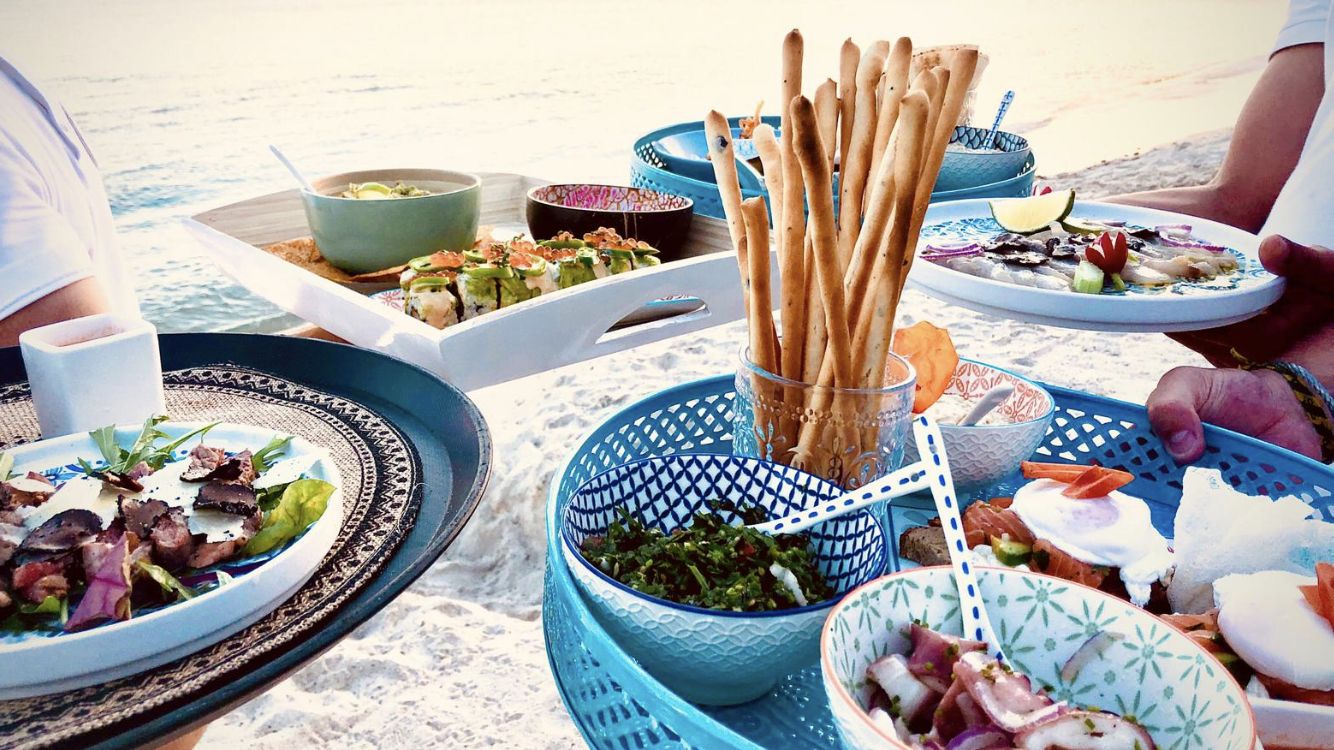 Plateaux d'apéritif servis sur le sable